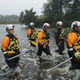 Members of the FEMA Urban Search and Rescue Task Force 4 from Oakland, California, search a flooded neighborhood for evacuees in Fairfield Harbour, North Carolina.